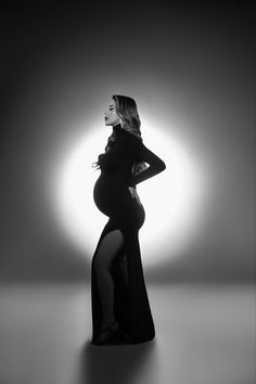 a pregnant woman in a long black dress