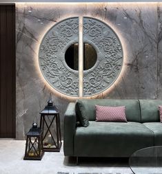 a green couch sitting in front of a wall with a circular mirror on it's side