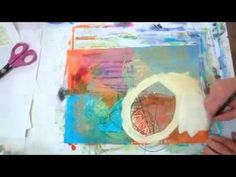 someone is using scissors to paint an abstract painting on paper with acrylic colors