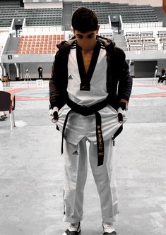 a man standing in front of an empty bleachers with his back to the camera