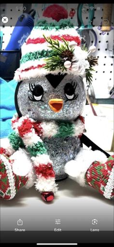 a stuffed penguin wearing a christmas hat and scarf