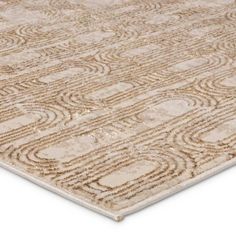 a beige rug with an intricate design on the top and bottom, it is made out of