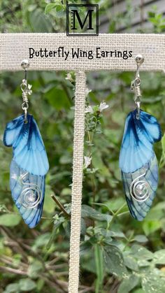 the butterfly wing earrings are blue and silver