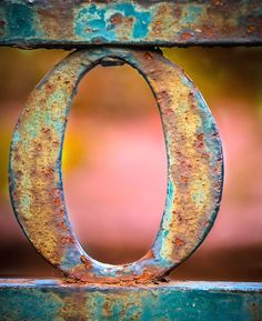 an old rusted metal object that looks like the letter o on it's side