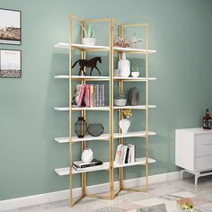 a living room with green walls and white shelving unit filled with bookshelves