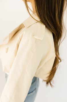 this cropped trench coat-esque jacket will take any spring outfit to the next level. it features chic tortoise shell buttons + has the most perfect cropped silhouette. whether you throw it on to elevate a basic outfit or use it as the focal point of your ensemble, it’s guaranteed to get you allll the compliments. butter // lapel collar, buttons, cuffed sleeves paired with our lotti tank + sicily distressed denim model is 5'7" + wearing a small measurements are approximate + taken while laying fl Chic Cropped Button-up Jacket For Work, Chic Collared Cropped Jacket With Button Closure, Trendy Cropped Jacket With Double Button For Work, Trendy Beige Collared Cropped Jacket, Trendy Button-up Cropped Jacket For Work, Chic Spring Button-up Cropped Jacket, Spring Cropped Jacket With Double Button Closure, Chic Cropped Jacket With Buttons For Fall, Chic Fall Cropped Jacket With Buttons