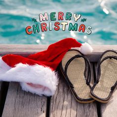 a pair of slippers sitting on top of a wooden deck next to a pool