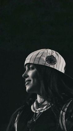 black and white photograph of a woman with a hat on her head looking off to the side