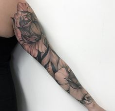 a woman's arm with flowers on it