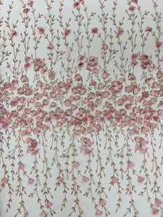 pink flowers on white fabric with brown stems and leaves in the center, as if it were embroidered