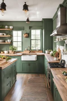 a kitchen with green painted cabinets and wooden counter tops, along with open shelves on the wall