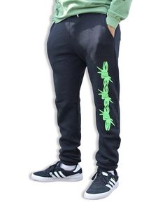 Black unisex jogger sweatpants with green barbed wire design on left leg paired with a green long-sleeve shirt and black and white Adidas sneakers. Photo is set on white background. These joggers have a slim-fit rather than the baggy fit many other sweatpants offer. Sizes XS-3XL available. Sweatshop-free, ethical fashion for tattoo enthusiasts. Tattoo Aesthetics, American Traditional Tattoo, Screen Printing Designs, American Traditional, Green Screen, Jogger Sweatpants, Comfy Fits