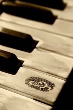 the keys of an old piano are black and white