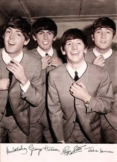 an old photo of four men in suits and ties