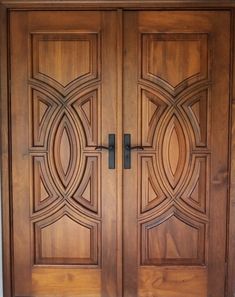 two wooden doors with decorative designs on them