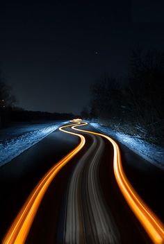 a long exposure shot of a road at night