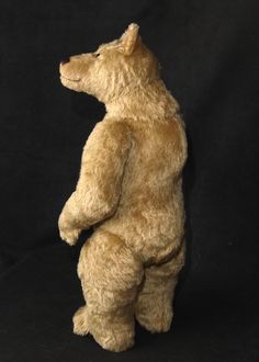 a brown teddy bear standing on its hind legs