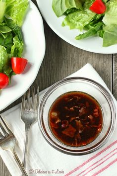 two plates with salad and a fork on the table