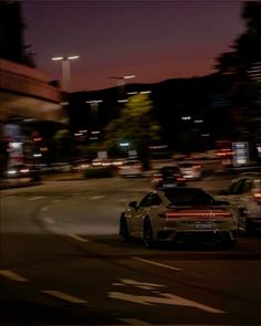 a car driving down the street at night