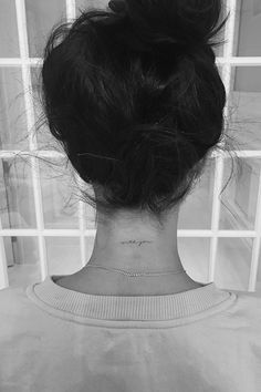 the back of a woman's head, with her hair in a bunt