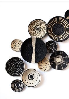 several black and white plates with designs on them are arranged in the shape of circles