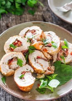 a plate filled with sliced up meat and garnished with parsley on top