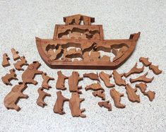 a wooden cutout of a boat and many smaller pieces