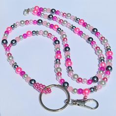 Dress up your ID holder with this Beautiful Blue Beaded Lanyard. If you wear a badge for work every day, these lanyard necklaces are a great way to brighten up your outfit.  This lanyard measures approx. 39 inches. It is made with shades of pink and grey faux pearls, glass beads and antique silver beads. It has a swivel lobster clasp to hold your employee ID, work badge or your keys.  This lanyard is made with 49 strand Jewelry wire for maximum durability. All of my items are handmade in Prince Lanyard Accessories, Lanyard Badge Holder, Lanyard Necklace, Beaded Lanyard, Work Badge, Jewelry Wire, Prince Edward Island, Prince Edward, Canada Post