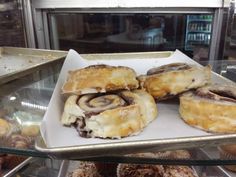 several pastries are on display in a bakery