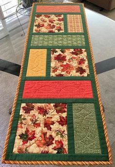 a quilted table runner is on the floor