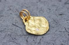 "A solid gold pendant set with a diamond, in 14k or 18k solid yellow, white or rose gold, in a boho antique style design. This solid gold antique-style pendant has a rustic textured and is set with a natural white diamond. The pendant has a gold arc on top, in which there are 2 gold loops, and has a delicate granulation all around it. This pendant is delicate but has a lot of character, and will upgrade any outfit you'll wear. This is a lovely pendant for everyday use, as for special occasions. Delicate Hand Forged Yellow Gold Jewelry, 14k Gold Single Diamond Pendant Jewelry, Wedding Hammered Diamond Jewelry, Diamond Coin Pendant Jewelry As A Gift, Hammered Diamond Jewelry For Anniversary, Delicate Hand Forged Gold Jewelry, Hammered Round Diamond Jewelry, Elegant Hammered Medallion Jewelry, Heirloom Gold Jewelry With Single Diamond