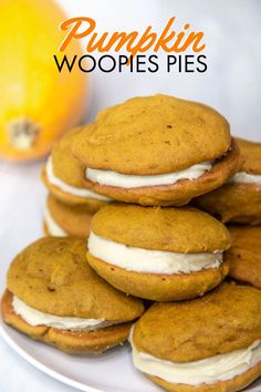 pumpkin whoopies pies on a plate with an orange in the background