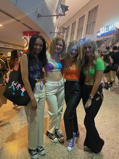 three women standing next to each other at an airport