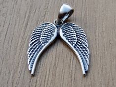 Double Angel wings pendant made from Sterling Silver .925 Chain not included. Height - 2,5 cm Width - 1,8 cm Weight - approx. 1-2 gr. The item is stamped/marked .925! 100% guaranteed quality. Images are real and not processed with Photoshop. All of this can be seen in the photos. NOTE: Due to the difference device/monitors being used, pictures may not reflect the actual colour of the item. Copyright infringement is prohibited! Work only in sterling silver, not in chrome plated pewter. Do not hes Silver Winged Engraved Jewelry, Spiritual Winged Sterling Silver Jewelry, Nickel-free Sterling Silver Angel Wing Jewelry, Nickel-free Winged Sterling Silver Jewelry, Winged Engraved Jewelry For Gifts, Engraved Winged Sterling Silver Jewelry, Sterling Silver Angel Wings Pendant, Sterling Silver Angel Wings Pendant Jewelry, Feather Fairy