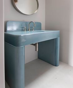 a bathroom with a blue sink and mirror