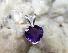 Genuine Purple Heart-Shaped Amethyst .925 Sterling Silver Necklace! Amethyst is the birthstone for those lucky people born in February!  Amethyst is known as the stone that brings peace of mind ... Please NOTE that the pictures shown here are larger than actual size to show details.  The Gemstone:   genuine, mined-from-the-ground Amethyst Shape - heart Measurement - 8mm x 8mm (as a size reference, a common pencil eraser is approximately 6mm in diameter) Carat Weight - 1.30 carats Cut - faceted Clarity - bright & clean Color - royal purple Mohs Scale of Hardness - 7.0 Gem Family - Quartz The Precious Metal:  The pretty Amethyst gemstone is mounted securely in a six-prong pendant.  The pendant is open on the back allowing more light to pass through ... all in .925 Sterling Silver.  Accompani Heart Cut Amethyst Birthstone Jewelry, Amethyst Gemstone Jewelry For Valentine's Day, Valentine's Day Amethyst Gemstone Jewelry, Purple Birthstone Necklace For Anniversary, Amethyst Gemstone Birthstone Necklace For Anniversary, Anniversary Amethyst Gemstone Birthstone Necklace, People Born In February, Born In February, Mohs Scale