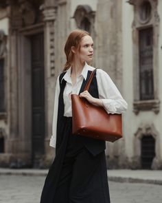 Your quintessential carry-all tote bag gets a sustainable upgrade with our Elba Tote: the durable, all-seasons bag that can take you from the office to the grocery store to a night on the town. Crafted in buttery vegetable-tanned leather that’s kind to the environment, this never-clunky tote can stand on its own, and its double-open pockets are ideal for carrying your notebooks or laptop. Stash your smaller essentials in our accompanying wristlet clutch, which looks elegant worn on its own, and Classic Shoulder Bag With Large Capacity, Everyday Structured Shoulder Bag With Smooth Grain, Timeless Structured Bag With Smooth Grain, Elegant Rectangular Bucket Bag For Business, Structured Shoulder Bag With Smooth Grain For Daily Use, Versatile Cognac Shoulder Bag With Smooth Grain, Classic Structured Shoulder Bag For Everyday, Classic Structured Everyday Shoulder Bag, Timeless Structured Everyday Bag