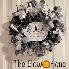 the bowtiquee is decorated with black and white ribbons, halloween decorations, and pumpkins