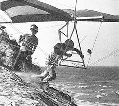 two men are wind surfing on the beach