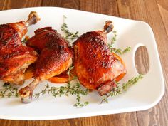 two pieces of chicken sitting on top of a white plate