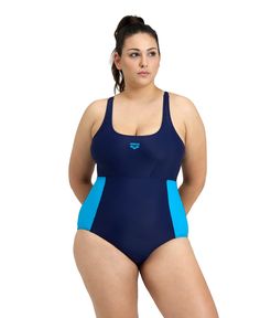 a woman in a blue swimsuit with her hands on her hips, posing for the camera