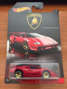 a red toy car with gold rims on it's sides and the logo lamborgundi