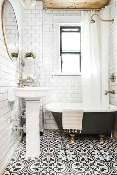 a bath room with a sink and a bath tub next to a window on the wall