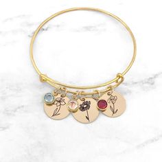 Birth Flower Bracelet • Birthstone Bracelet • Birth Month Flower Bracelet • Personalized Birth Flower Bracelet • Gift For Mom Have this bangle bracelet personalized with the birth flower(s) and birthstone(s) of your choice! Personalized jewelry makes the perfect gift for so many occasions. Each Adjustable Crystal Bracelet With Flower Charm, Mother's Day Birth Flower Bracelets, Mother's Day Flower Bracelet With Birth Flowers, Mother's Day Birth Flower Bracelet, Flower Charm Bracelets As Gifts, Adjustable Flower Crystal Bracelet Gift, Adjustable Flower-shaped Charm Bracelets, Adjustable Flower-shaped Bracelets With Charms, Adjustable Flower Charms Bracelets