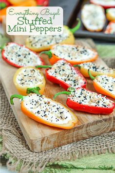 stuffed mini peppers with cheese and herbs on a cutting board next to other food items