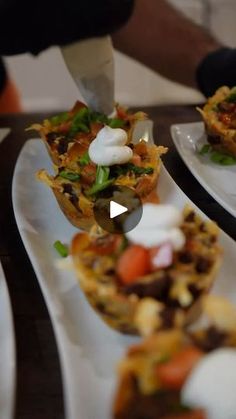 several small white plates filled with food on top of a table