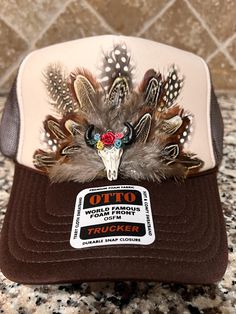 Feathered Trucker Hat. Each feather individually placed by hand on the hat, therefore all hat designs and patterns will vary, making each hat unique and 1 of a kind! **WARNINGS** *Keep away from children and pets. The Freshiry is NOT RESPONSIBLE for any damages or injuries due to misuse. SOCIALS: Add our shop to your favorites!  Follow us on our FB, Instagram and TikTok pages @the_freshiry for updates on new products! POLICIES: All products are FINAL sale, but should you have an issue, please contact us within 2 days of delivery of your order and I will do my best to resolve it. Note: Products are handmade and may have slight imperfections.  The Freshiry is NOT RESPONSIBLE for any damages or injuries due to misuse. To view our entire policies, please click here: https://www.etsy.com/shop/t Brown Trucker Hat For Western-themed Events, Western Style Trucker Hat For Beach, Western Beach Trucker Hat, Western Style Summer Festival Trucker Hat, Western Style Trucker Hat For Summer Festivals, Country Style Snapback Trucker Hat For Western Events, Country Style Trucker Hat For Western-themed Events, Country Style Festival Trucker Hat, Brown Western Mini Hat