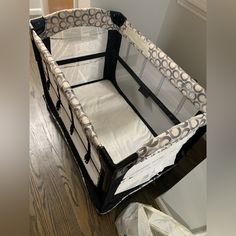 a baby crib sitting on top of a hard wood floor