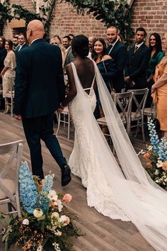 Black bride walking down the aisle in a Made With Love lace wedding dress with Watteau train Wedding Flowers Black, Bride Walking Down The Aisle, Watteau Train, Black Brides, Bride Top, Vegan Wedding, 2025 Wedding