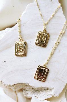 our *pre-order* square pendant initial necklaces are the go-to essential for any look you're pulling these days // each monogram pendant features a design in dimensional relief that has been polished to perfection to sparkle against your skin the pendant measures approximately 1” and comes on an 18” chain with an added extender chain gold plated: this necklace is tarnish resistant, the gold plating receives an additional protective coat that allows for frequent wearing without the worry of your Letter Necklace Initials, Square Pendant Necklace, Gold Pendent, Dainty Initial Necklace, Monogram Pendant, Mobile Boutique, Letter Pendant Necklace, Initial Necklace Gold, Initial Pendant Necklace